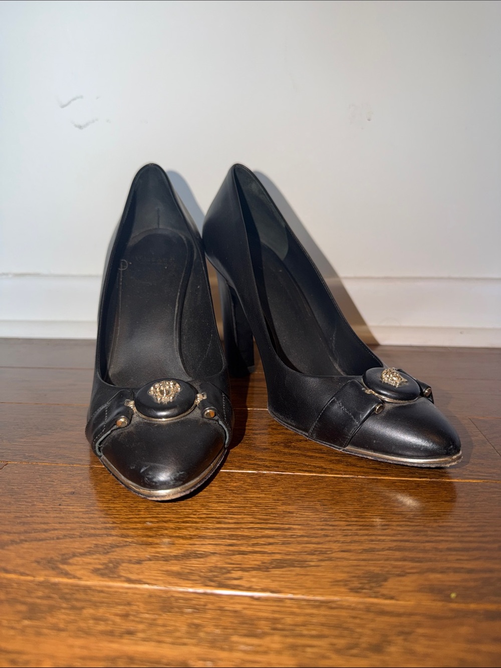 Versace Black Leather Pointed-Toe Pumps with Gold Medallion